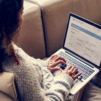 woman filling online registration form on her laptop